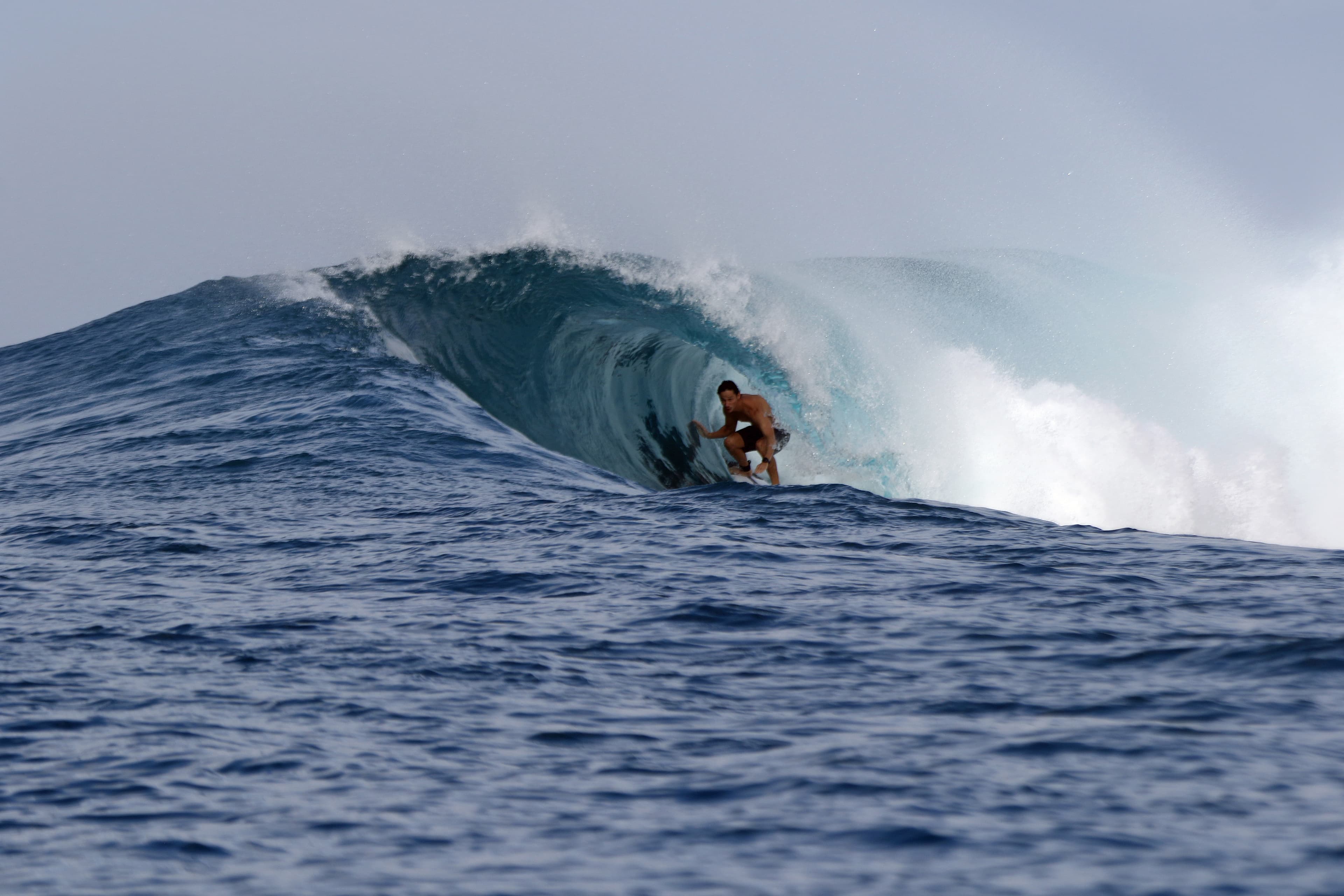 Dropping into a wave in the Mentawai Islands